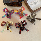 A collection of colorful bow hair clips arranged on a surface