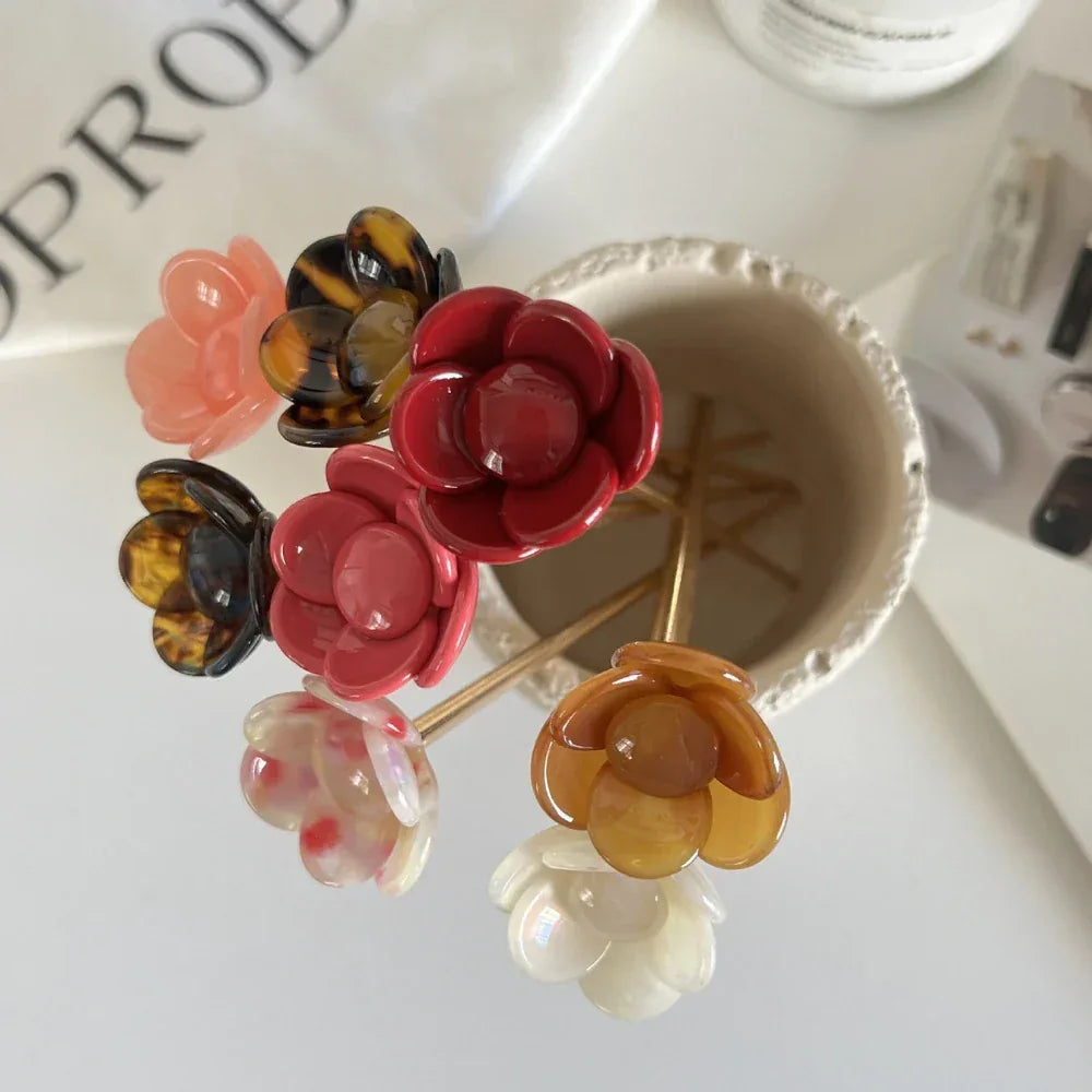 flower hairpins arranged in a ceramic holder