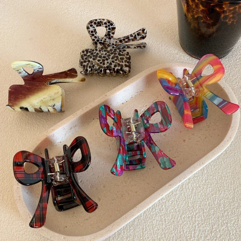 A variety of bow hair clips displayed on a tray