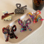 A variety of bow hair clips displayed on a tray
