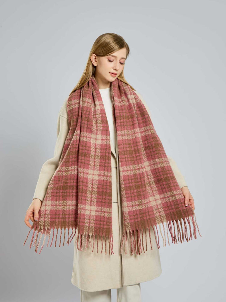 Close-up of a woman's face and shoulders showcasing a pink and tan plaid scarf.