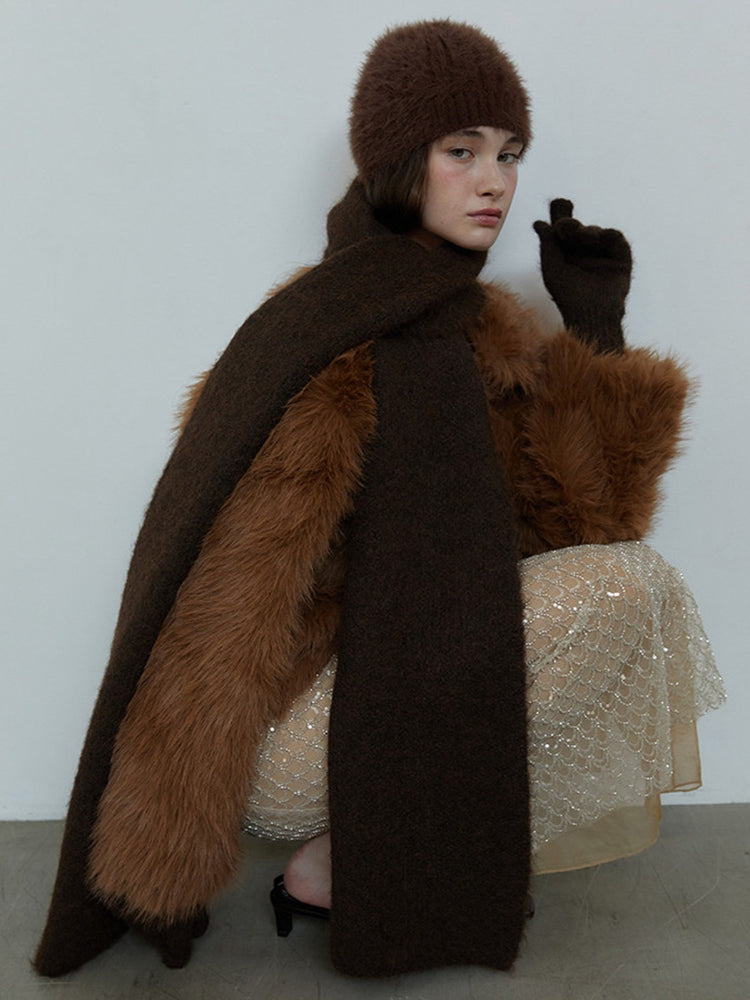 Model in a brown fuzzy outfit, including a scarf and faux fur jacket, with a sequined skirt Secondary image