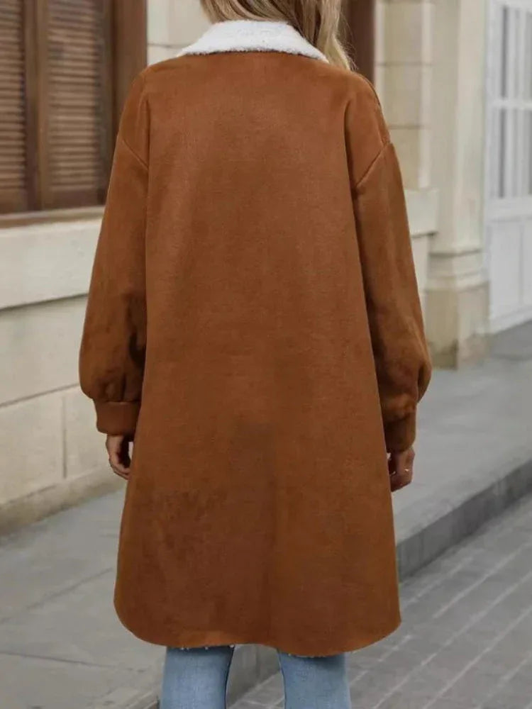 Back view of a woman wearing a long brown fleece jacket with sherpa collar.