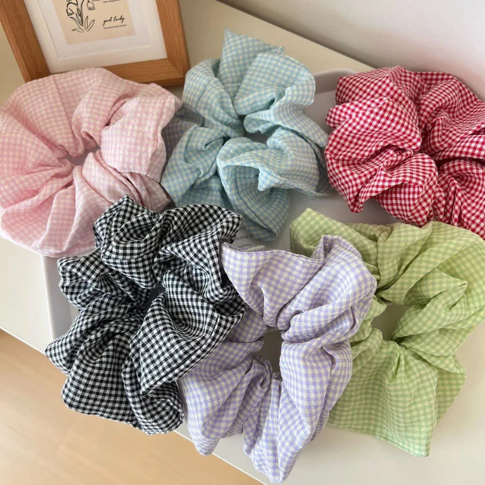 Close-up of six pastel and darker toned gingham scrunchies