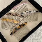 Group of decorative hair combs displayed in a tray