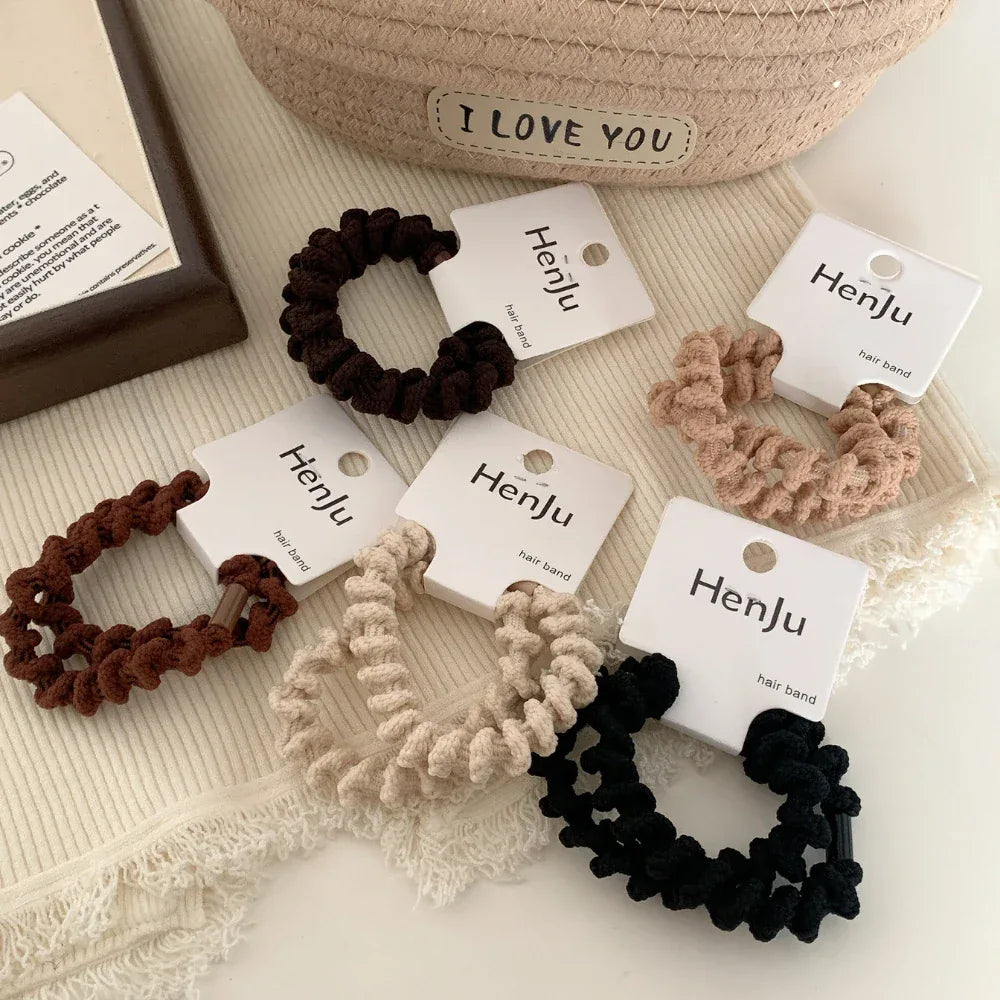 Assortment of spiral hair ties in various neutral colors