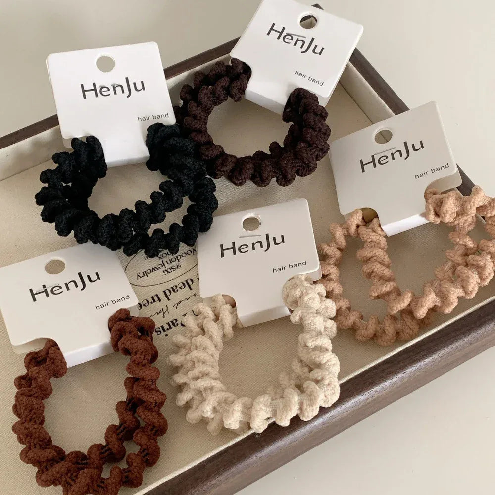 Collection of spiral hair ties in a tray