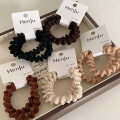 Collection of spiral hair ties in a tray