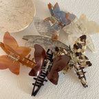 A collection of butterfly hair claw clips in various patterns and colors