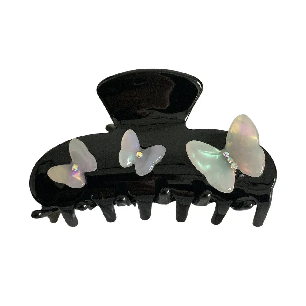 Black claw clip with iridescent butterfly embellishments and gem accents