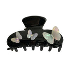 Black claw clip with iridescent butterfly embellishments and gem accents