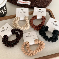 Group of spiral hair ties on a textured surface