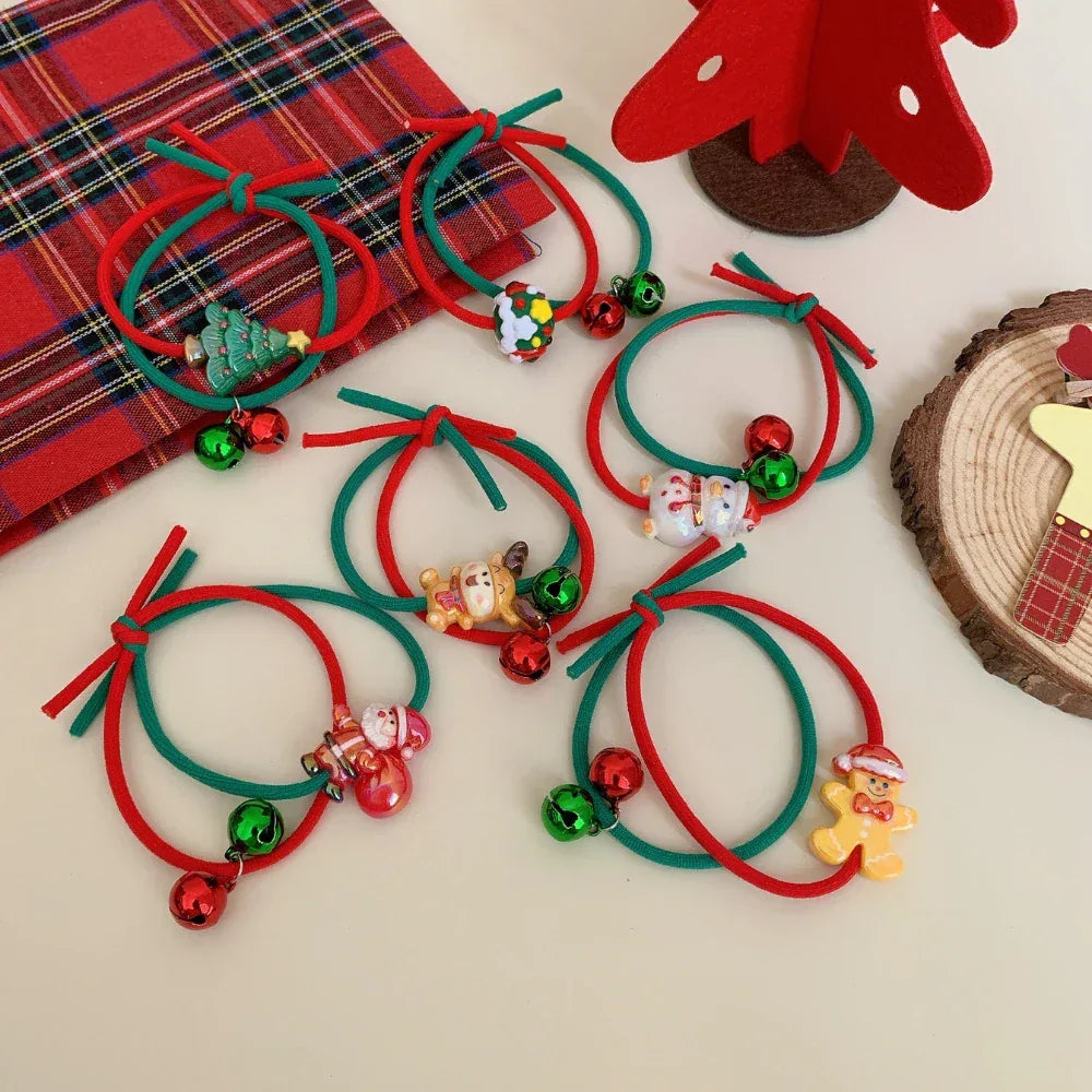 Set of red and green Christmas hair ties adorned with festive charms and bells