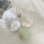 three decorative seashell hair clips with rhinestones and glitter