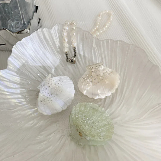 three decorative seashell hair clips with rhinestones and glitter