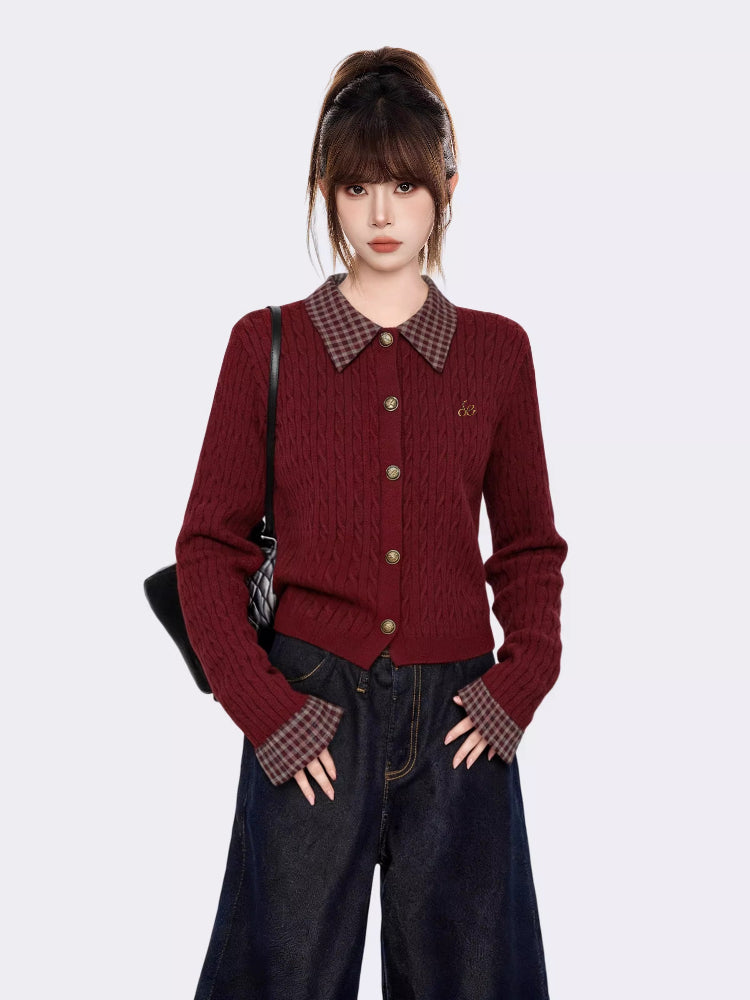 Woman wearing a burgundy cable knit cropped cardigan with a plaid collar and cuffs, paired with dark wash wide-leg jeans.