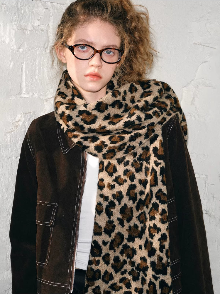 Model wearing a brown jacket with a leopard print scarf and black pants. Main image
