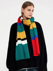 Woman wearing a black sweater and a multicolored striped knit scarf