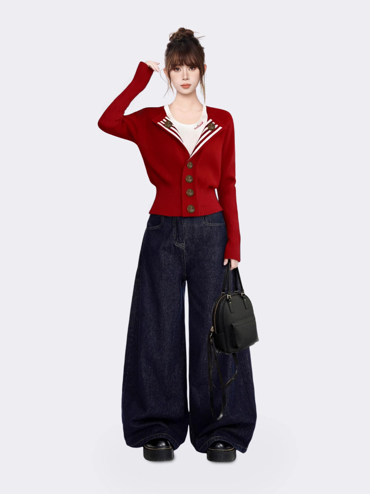 Woman posing in a red knit cardigan, white t-shirt, and dark wash wide-leg jeans, with a black backpack