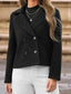 Woman wearing a black double-breasted cropped jacket with white pants