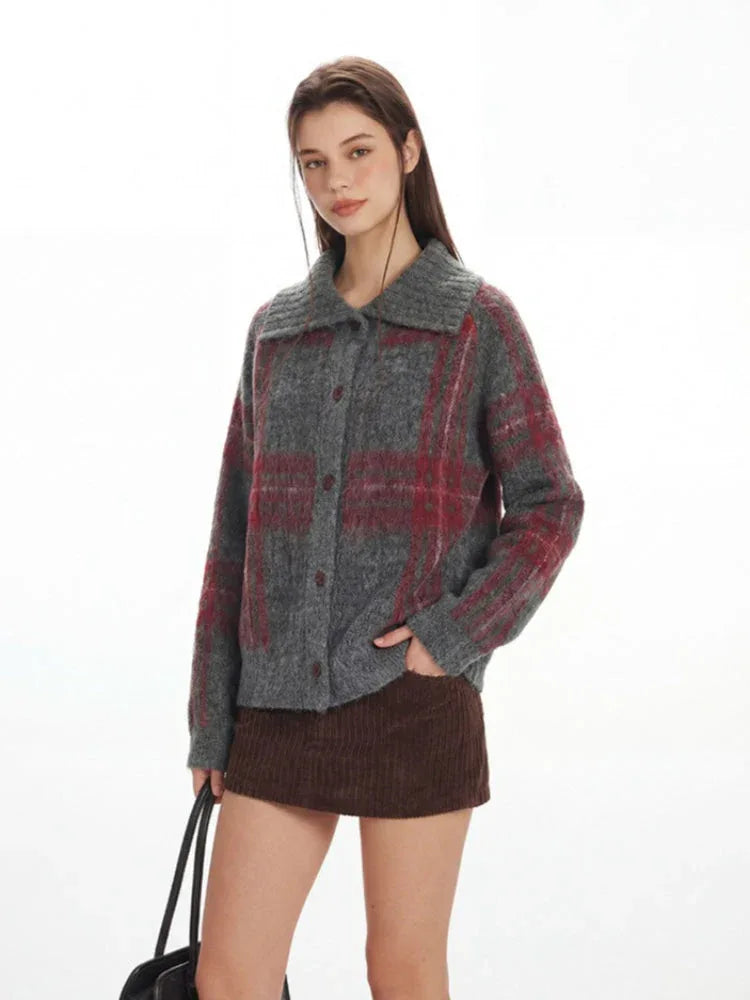 Woman in a grey plaid knit jacket with her hand in her pocket, styled with a brown mini skirt.