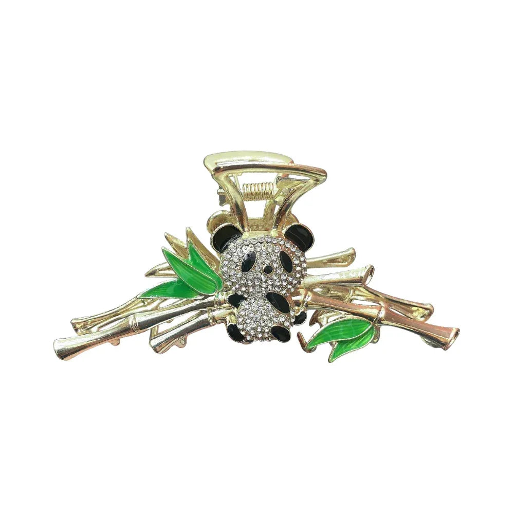 Gold claw clip with a panda and bamboo design, rhinestones, and green enamel leaves, isolated on a white background.