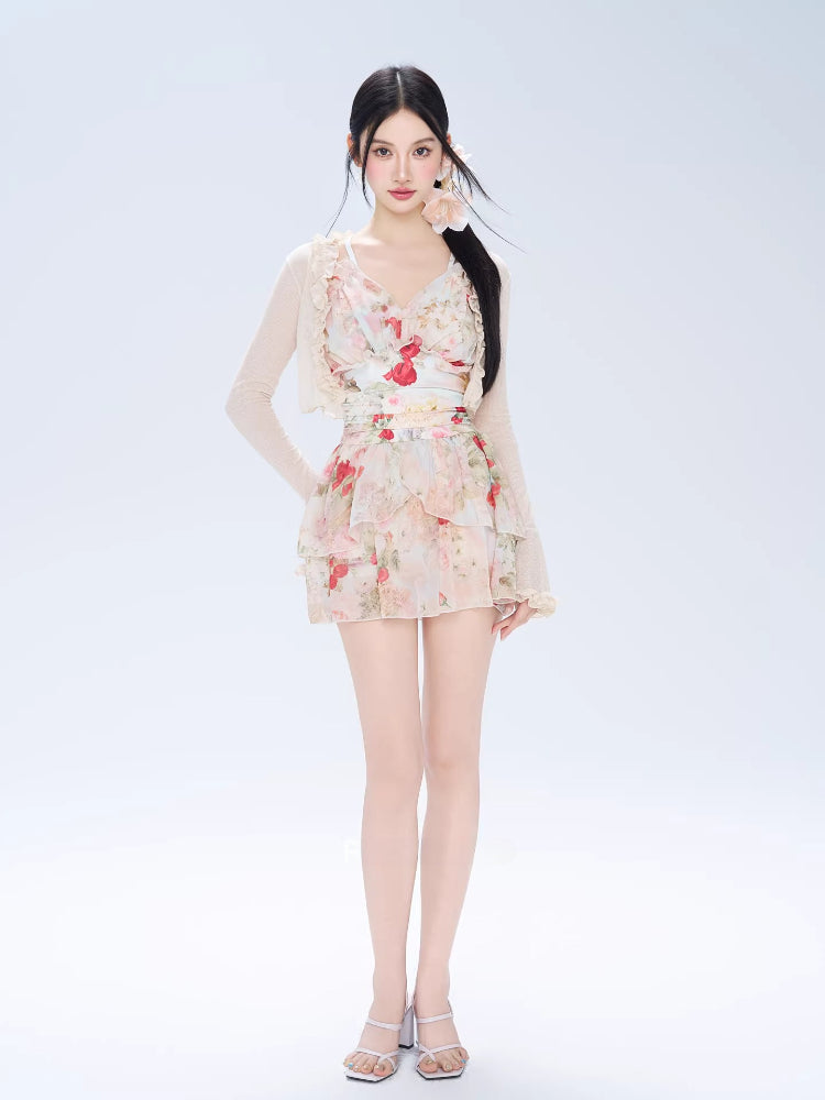 Full body shot of a woman in a floral print mini dress and cardigan