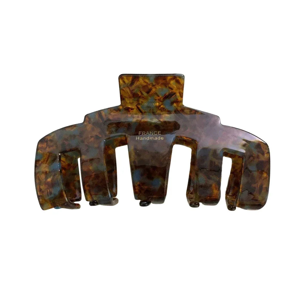 A single tortoiseshell claw hair clip on a white background. Main image