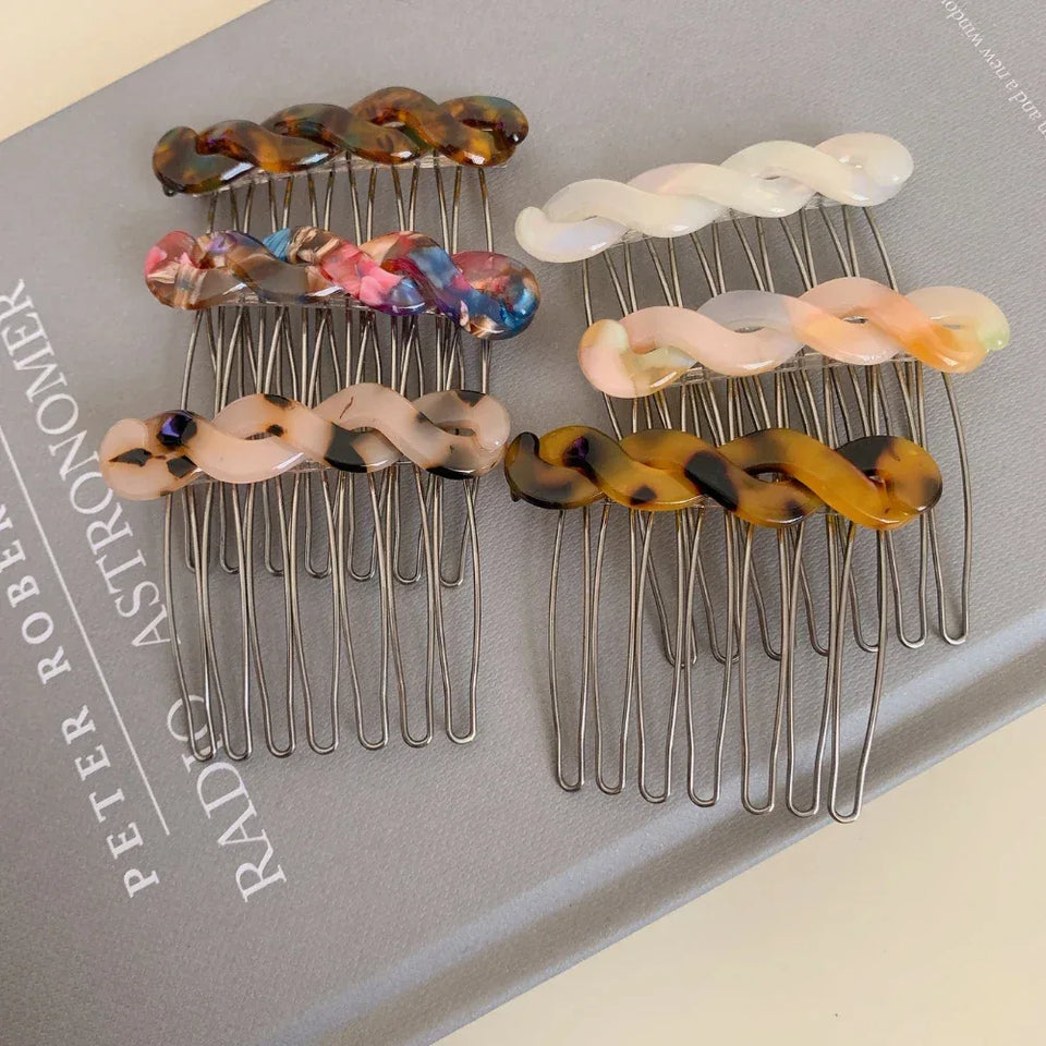 Collection of assorted marbled resin twisted hair combs with metal teeth Secondary image