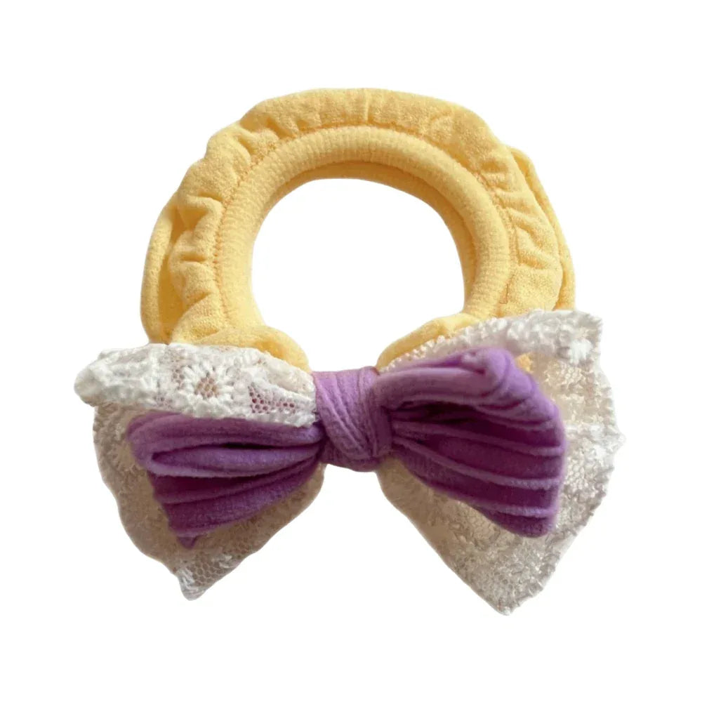 Yellow scrunchie with purple bow and white lace trim
