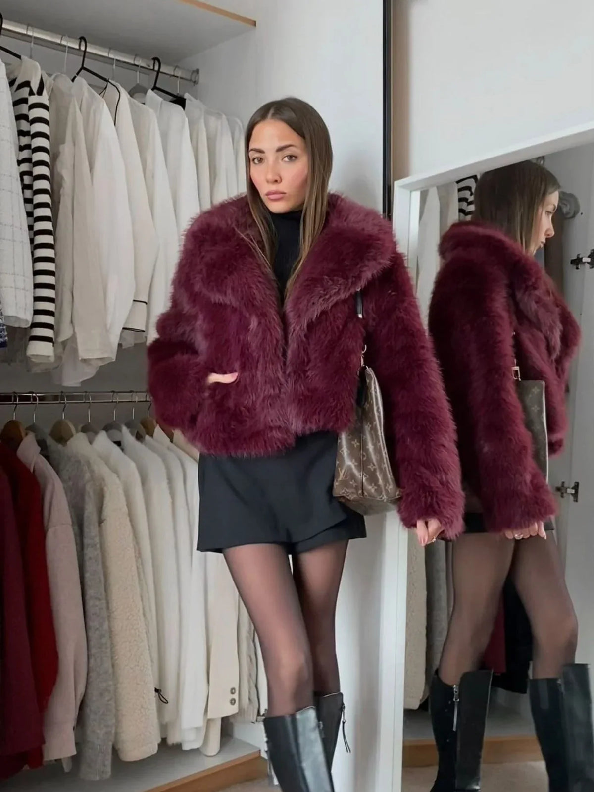 Woman wearing a burgundy faux fur jacket with a black mini skirt and black boots
