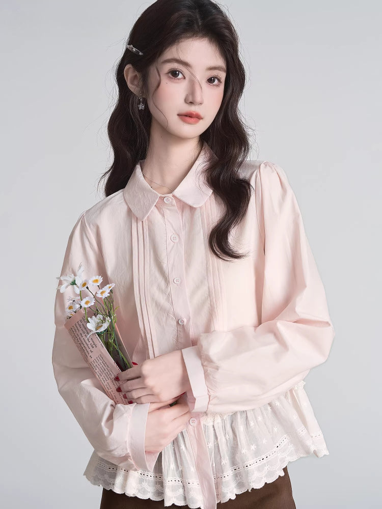 Woman holding a bouquet of flowers while wearing a light pink ruffled peplum blouse with a Peter Pan collar and lace trim.
