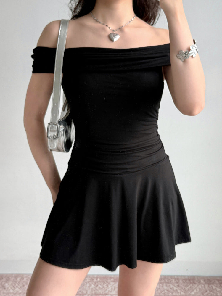 Close-up of the upper body of a person wearing a black off-the-shoulder dress and silver accessories.