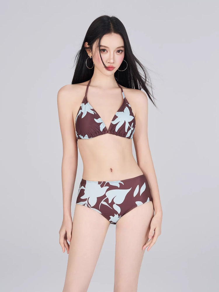 Woman wearing a brown and light blue floral print bikini set.