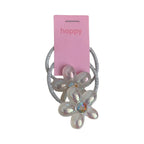 Close-up of a sparkly flower hair tie with iridescent petals and a colorful gem center.