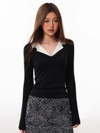 Model wearing a black long-sleeved top with a white contrast collar and a leopard print skirt.