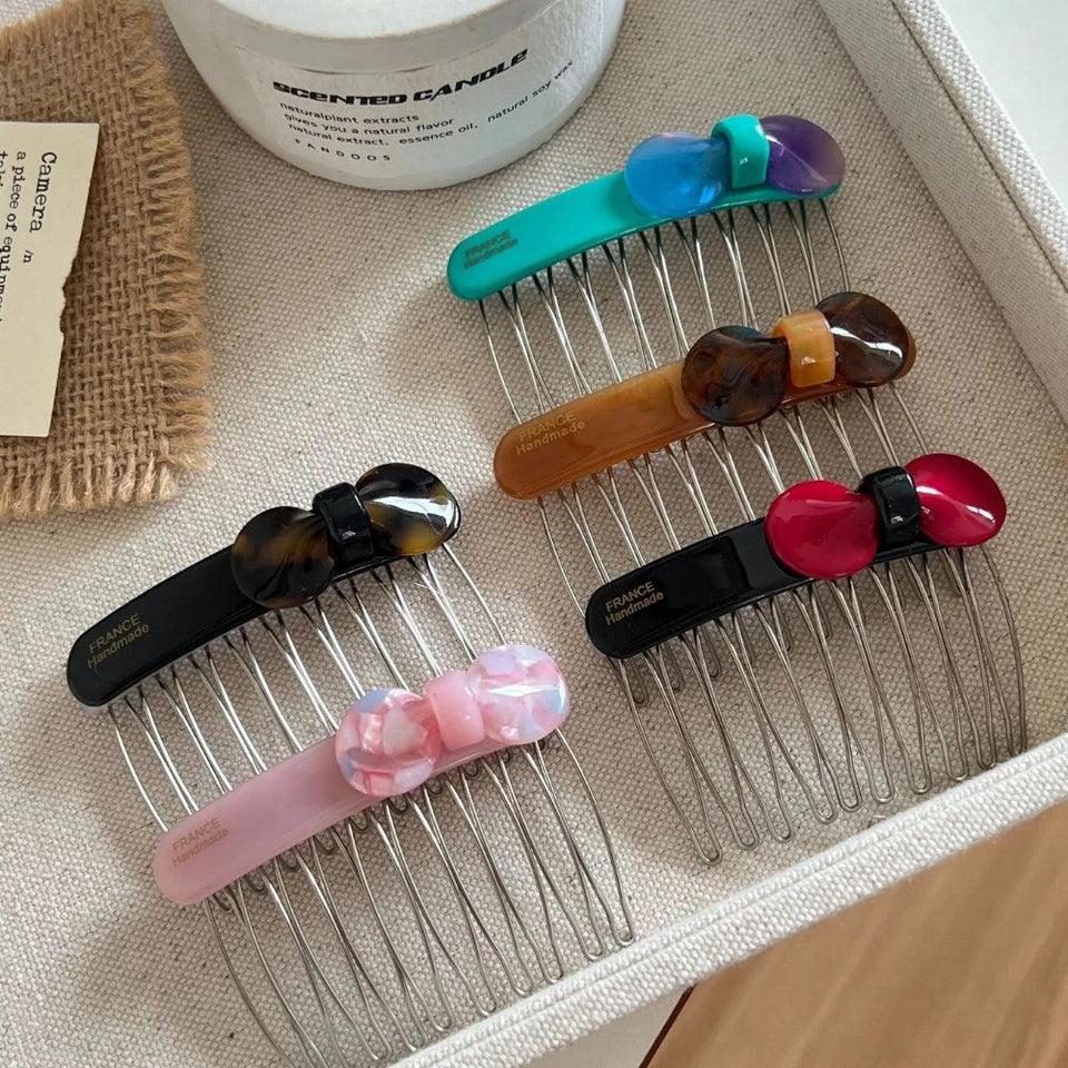 Assortment of colorful hair combs with bow accents Secondary image