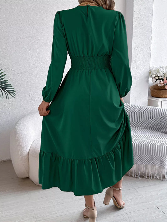 back view of a woman wearing a long green dress