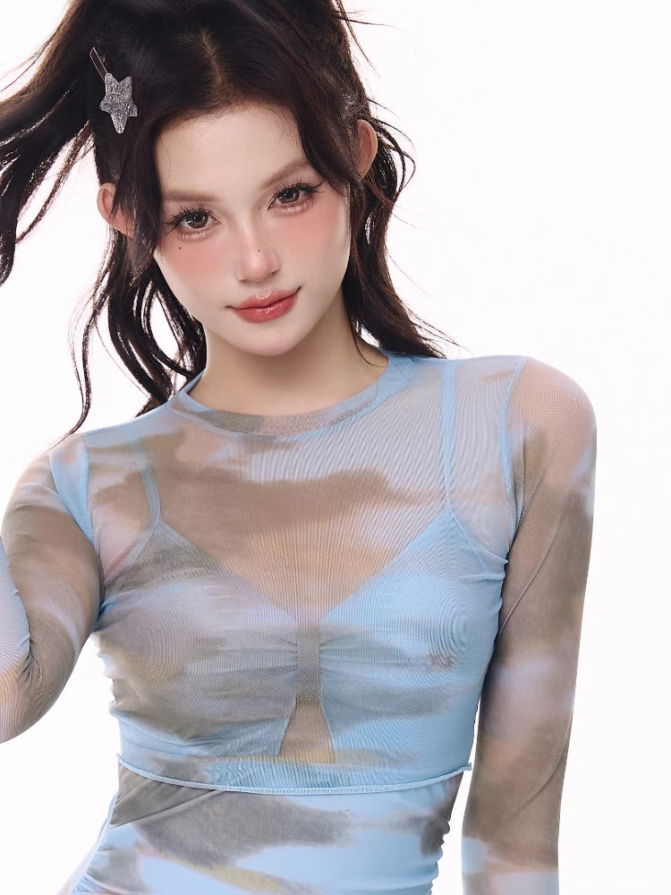 Close-up of the sheer mesh top of the swimsuit, showing the cloud print and ruched detail.