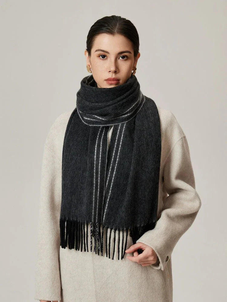 Close-up of a woman wearing a charcoal gray scarf with white stripes
