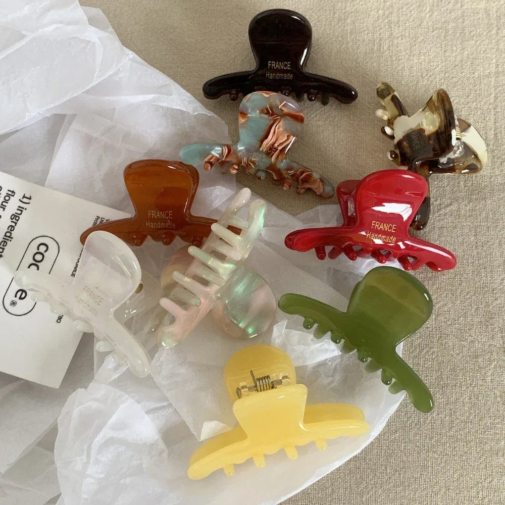 Collection of colorful acetate claw hair clips with "FRANCE Handmade" inscription