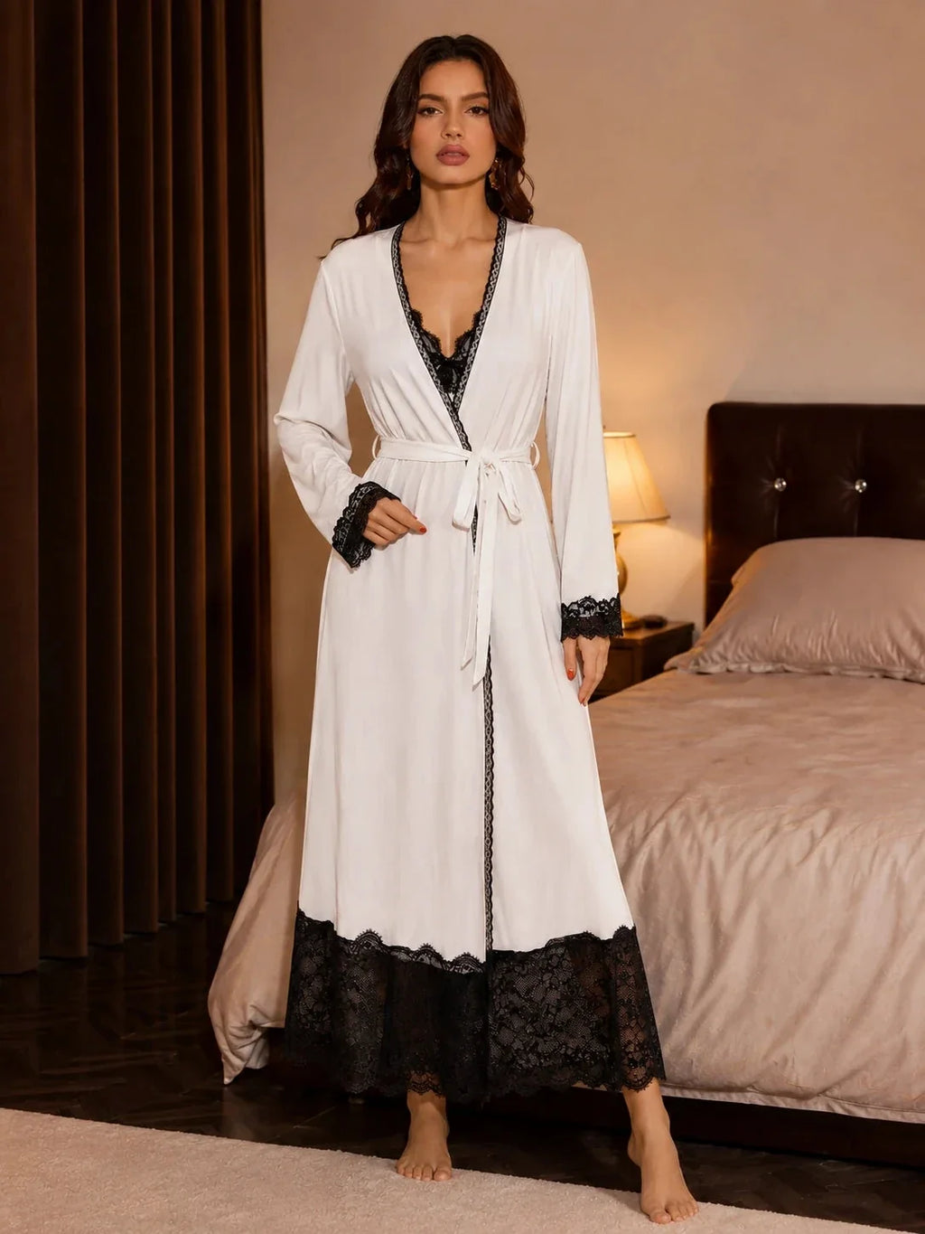 Close-up front view of the white nightdress with black lace details on the bust and hem.