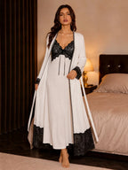 Full length view of the white robe with black lace trim on the cuffs and hem, worn open over the nightdress.