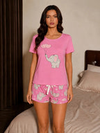 Detail of the elephant and heart print on the pink pajama shorts with a white drawstring.