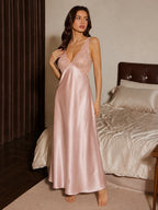Woman modeling a long pink nightgown with lace details