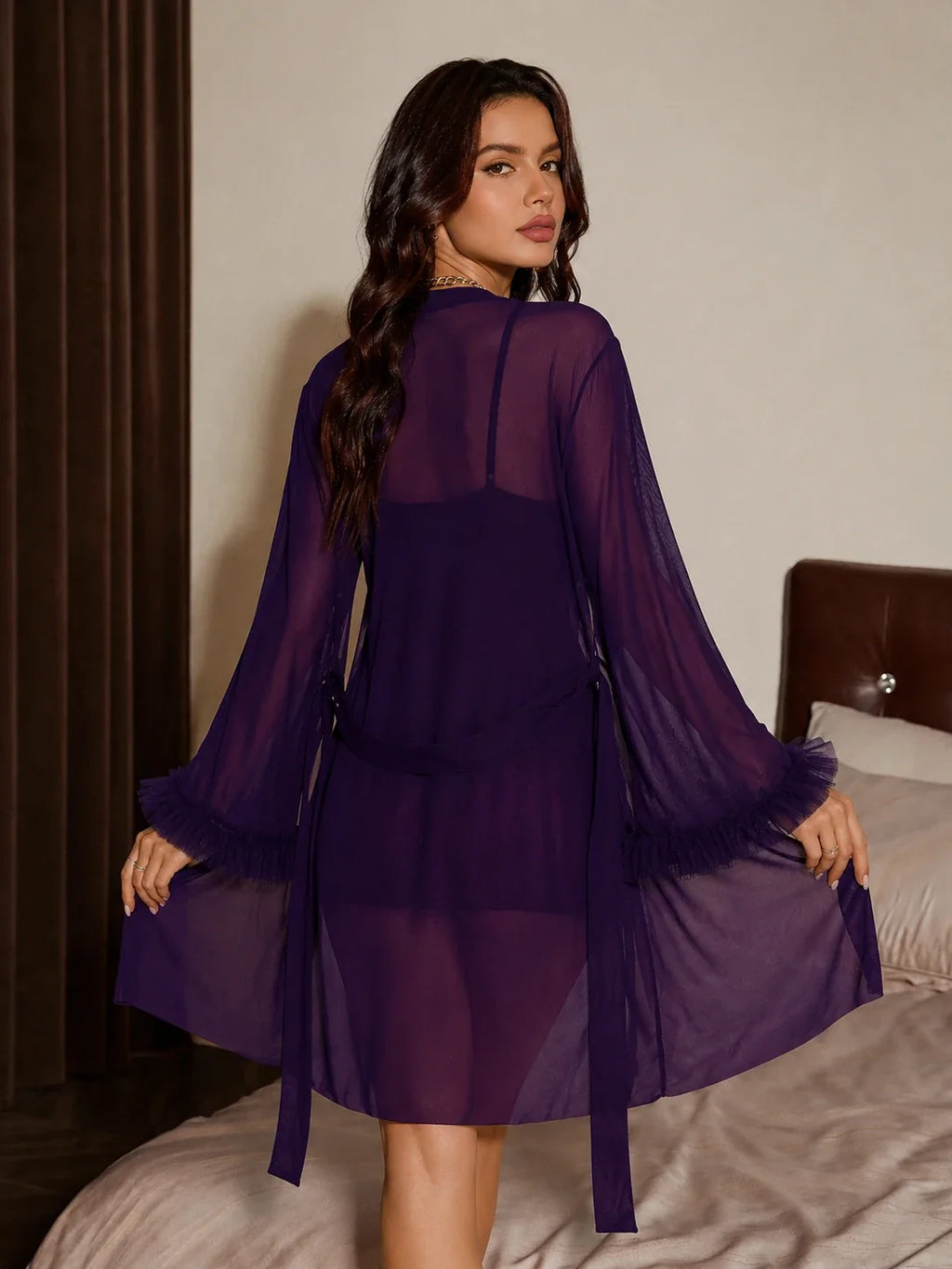 Back view of a woman wearing a purple lace camisole and shorts set with a matching sheer robe, showing the tie-front detail.