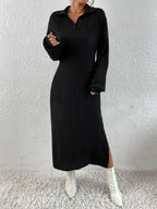 Woman wearing a black long-sleeved ribbed knit dress with a high slit and white boots, front view.