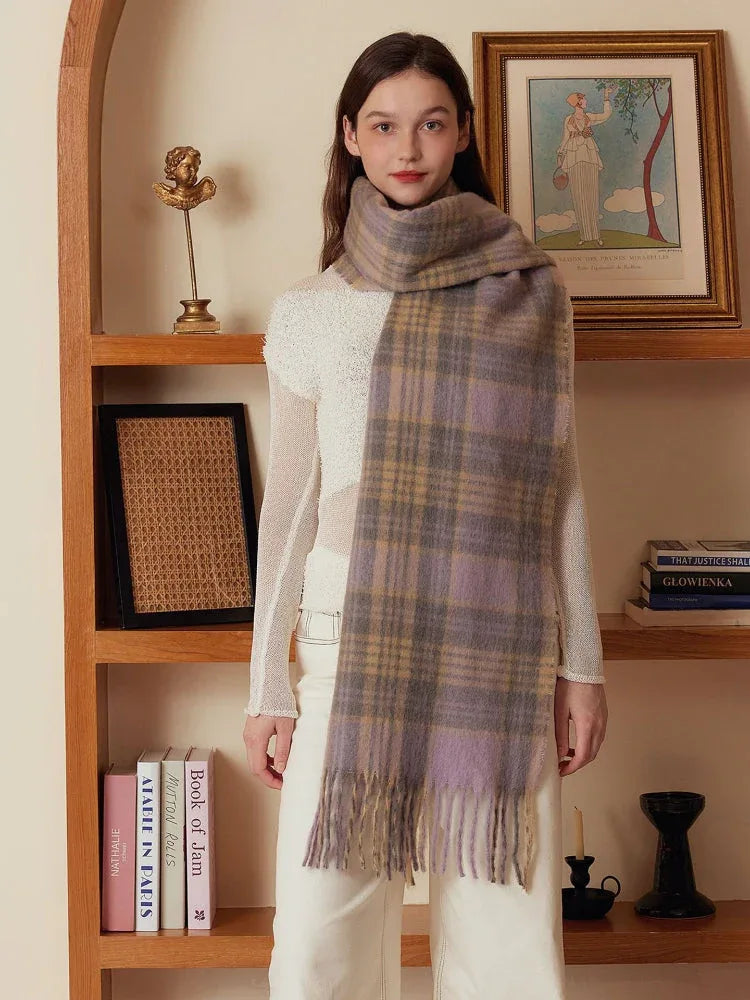 Model wearing a light purple and tan plaid scarf with fringe