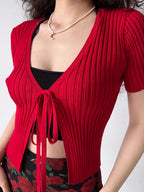 Red ribbed knit tie-front crop top with a black underlayer.