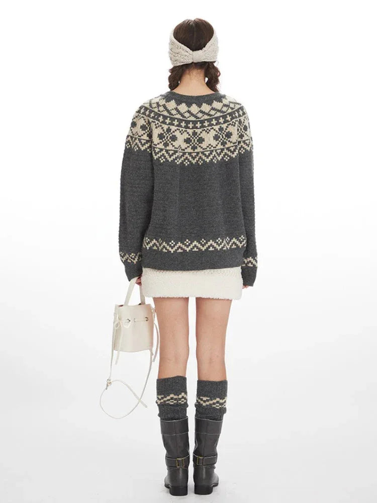 Woman wearing a grey and cream Fair Isle knit sweater, white mini skirt, grey knee-high socks, and black boots, back view